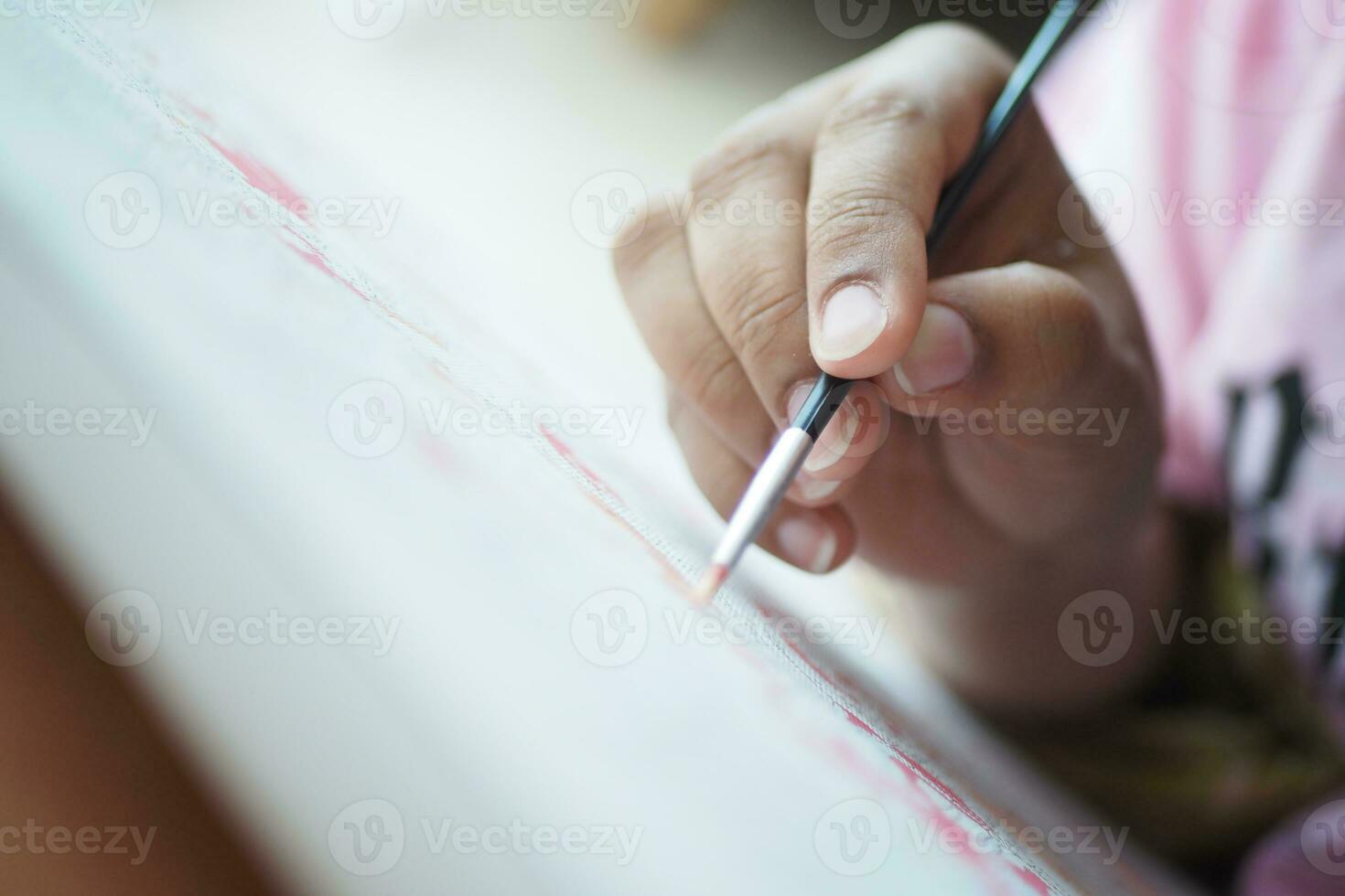 women hand holding brush with paint photo