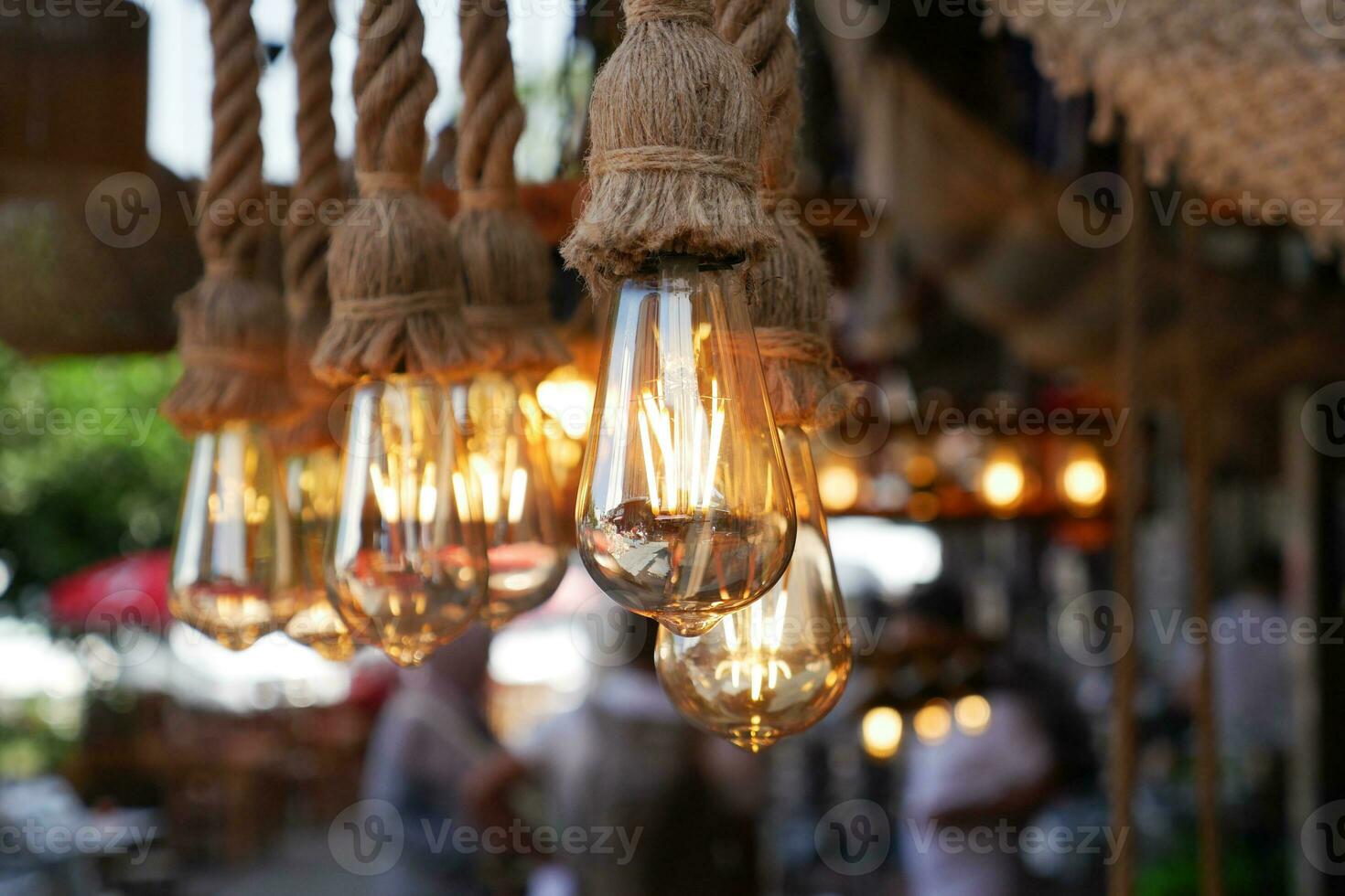 Burning stylish light bulbs at cafe photo
