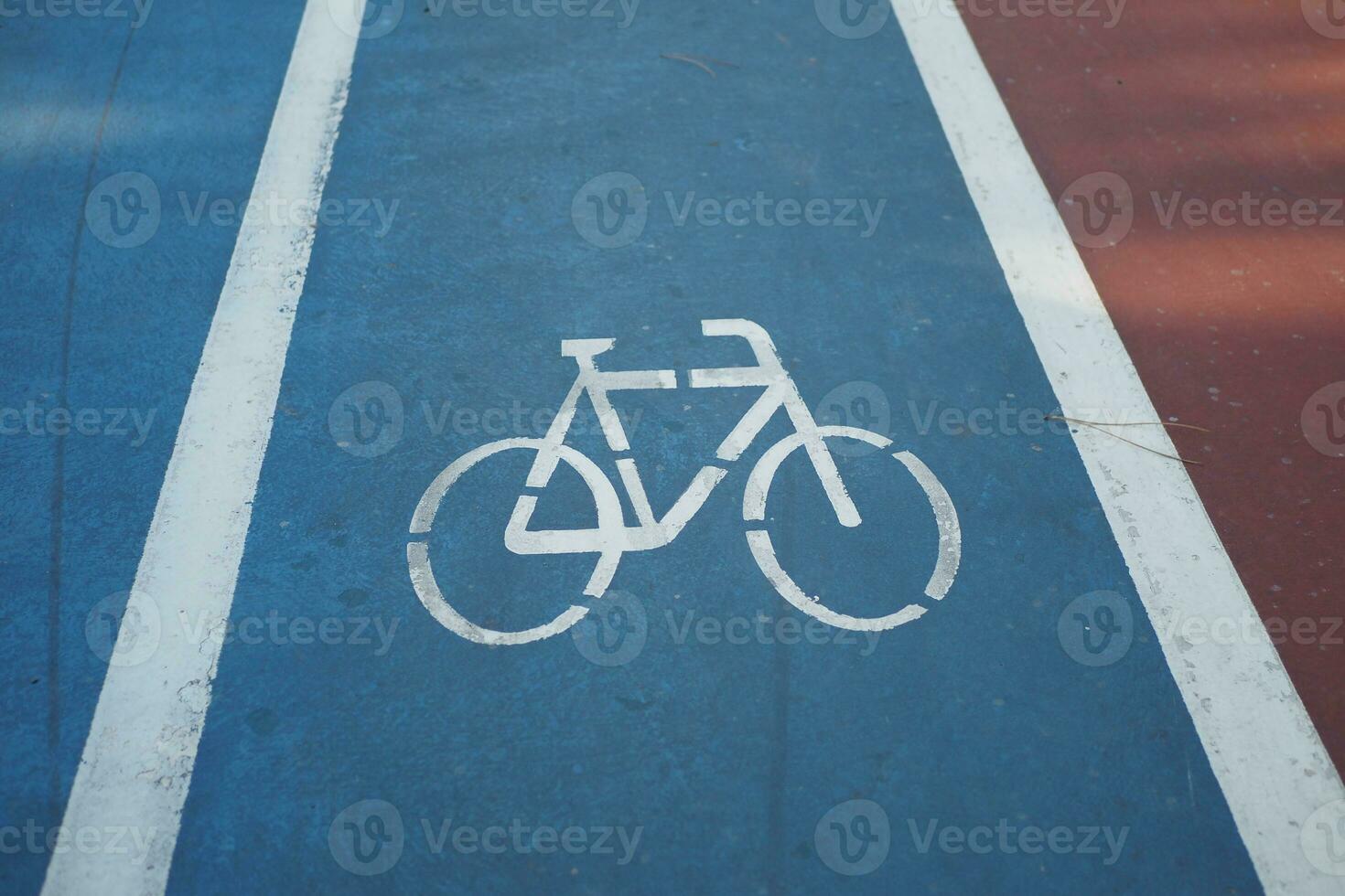 Bicycle symbol on the blue road surface photo