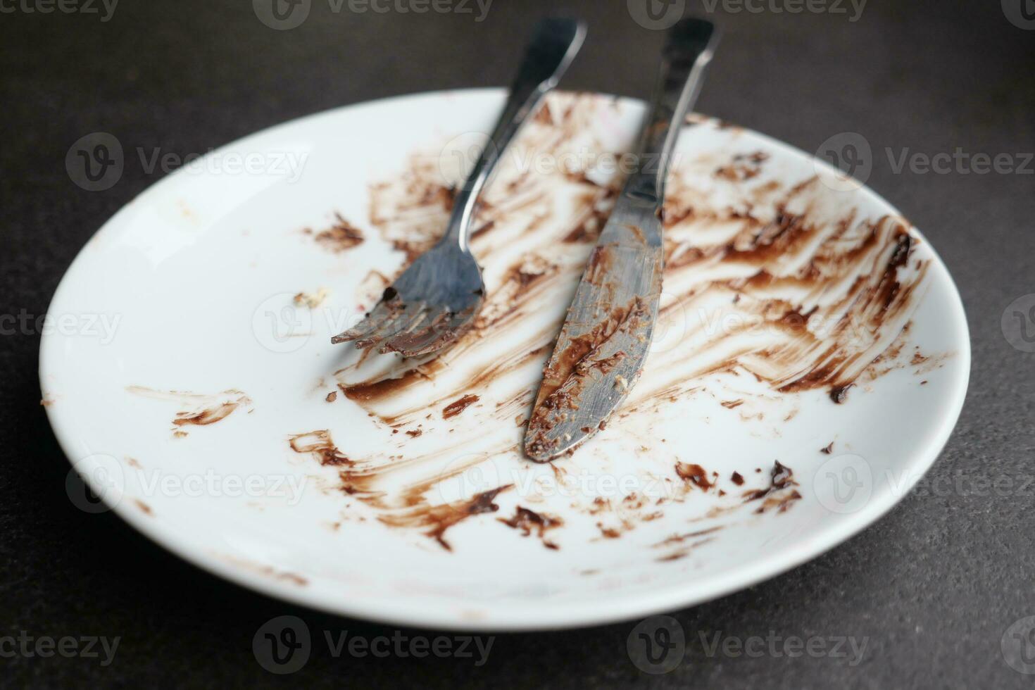 Empty plate after eating on table photo