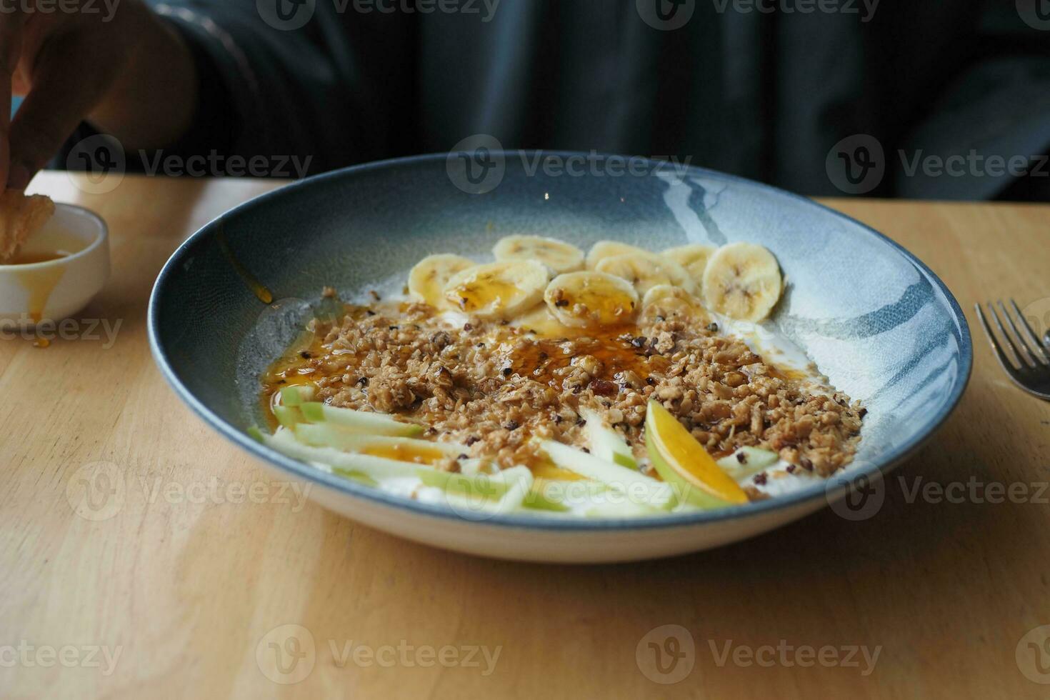 Breakfast Granola Bowl With Banana And honey photo