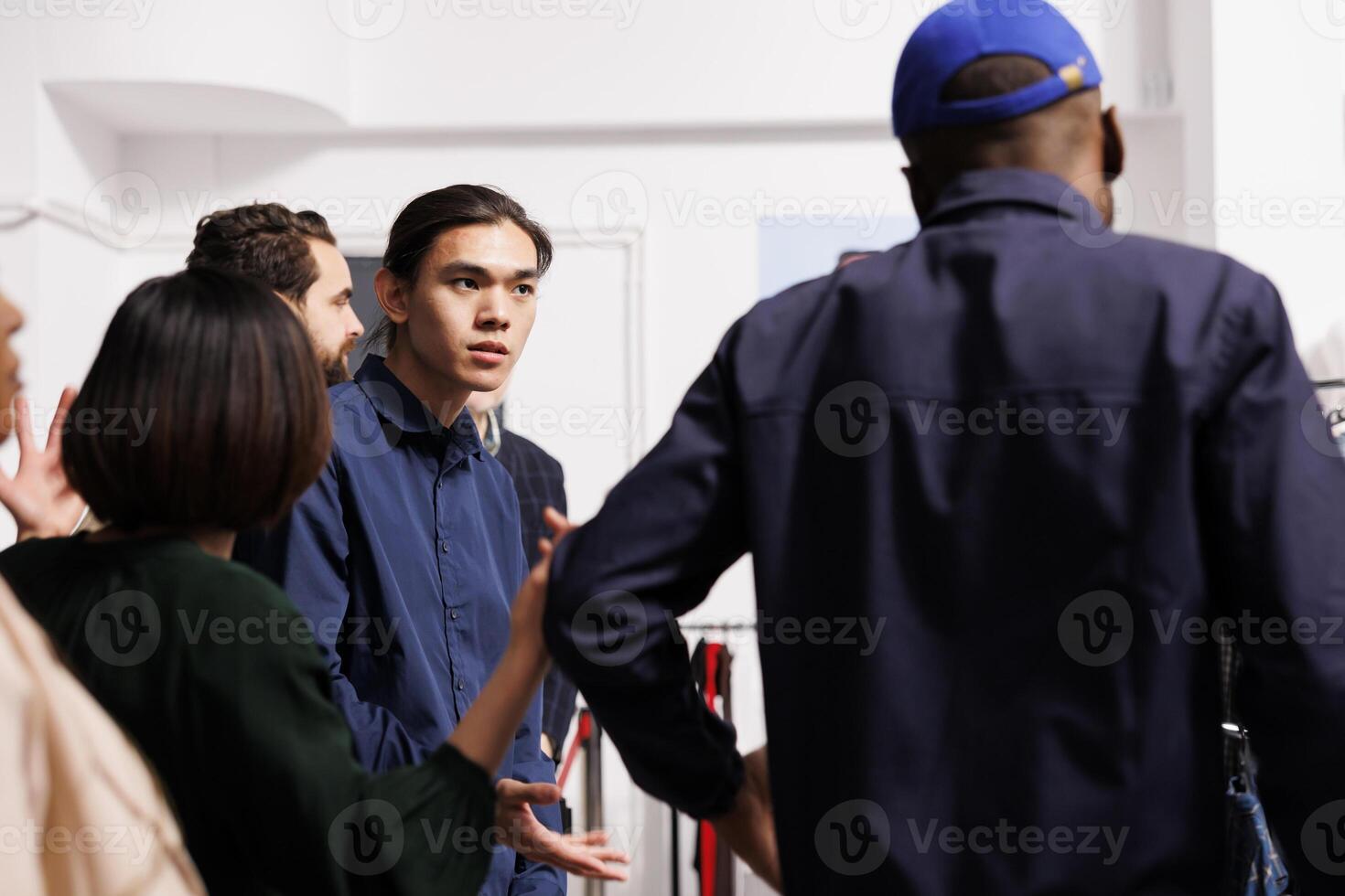 Rude angry shoppers bargain hunters arguing with police worker while waiting in line at store entrance before its open. Restless anxious diverse people wait for Black Friday sales photo