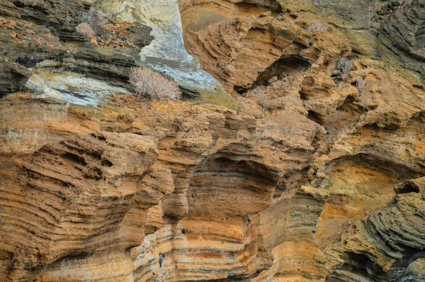 a rock formation with many different colors photo