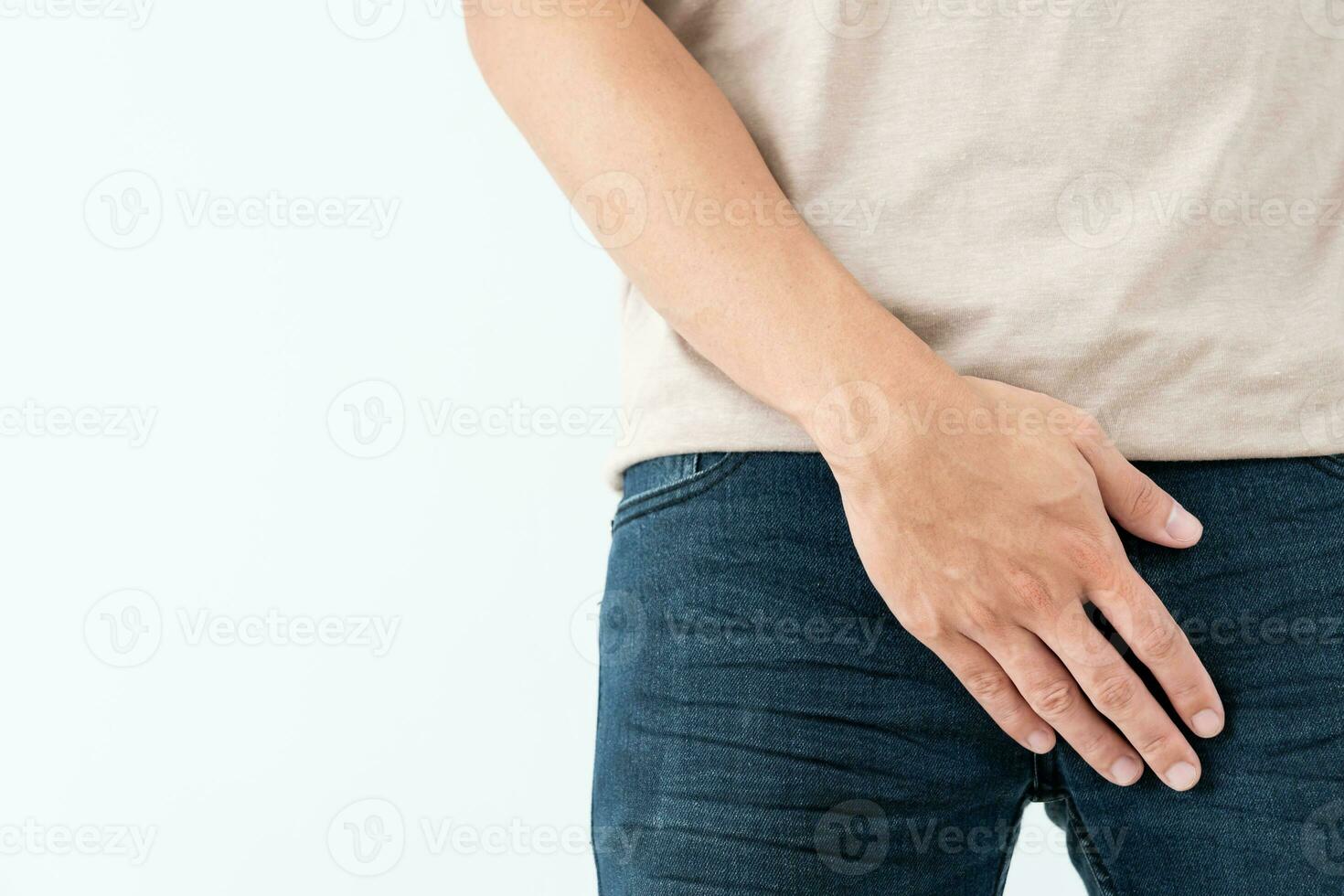 Man hold hand in front of private parts feeling discomfort from disease and inflammation. Venereal, testicular cancer. bladder problems, erectile dysfunction, premature ejaculation, prostate cancer photo