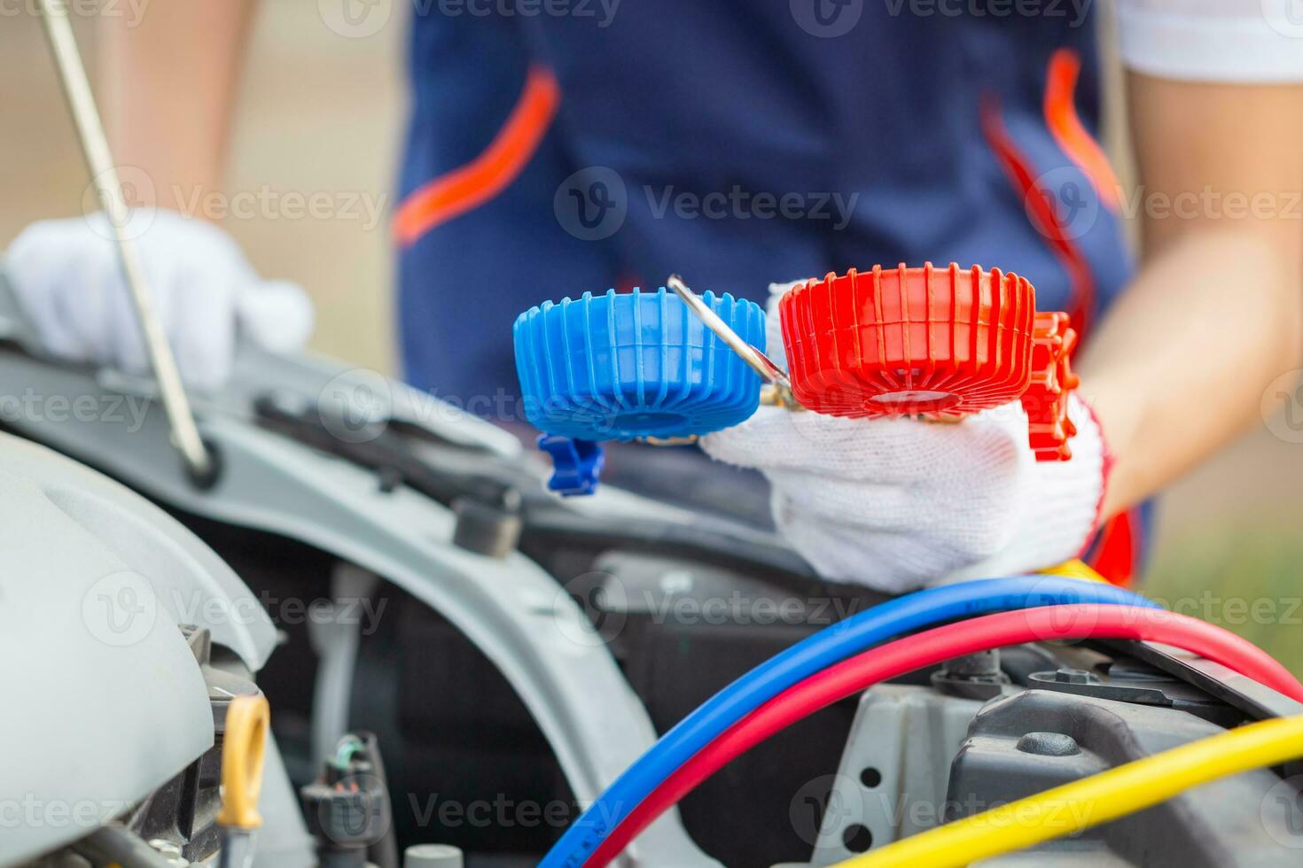 Repairman holding monitor tool to check and fixed car air conditioner system, Technician check car air conditioning system refrigerant recharge, Air Conditioning Repair photo