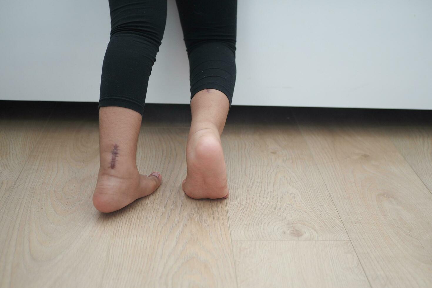 low angle view of A child walking on tiptoes photo