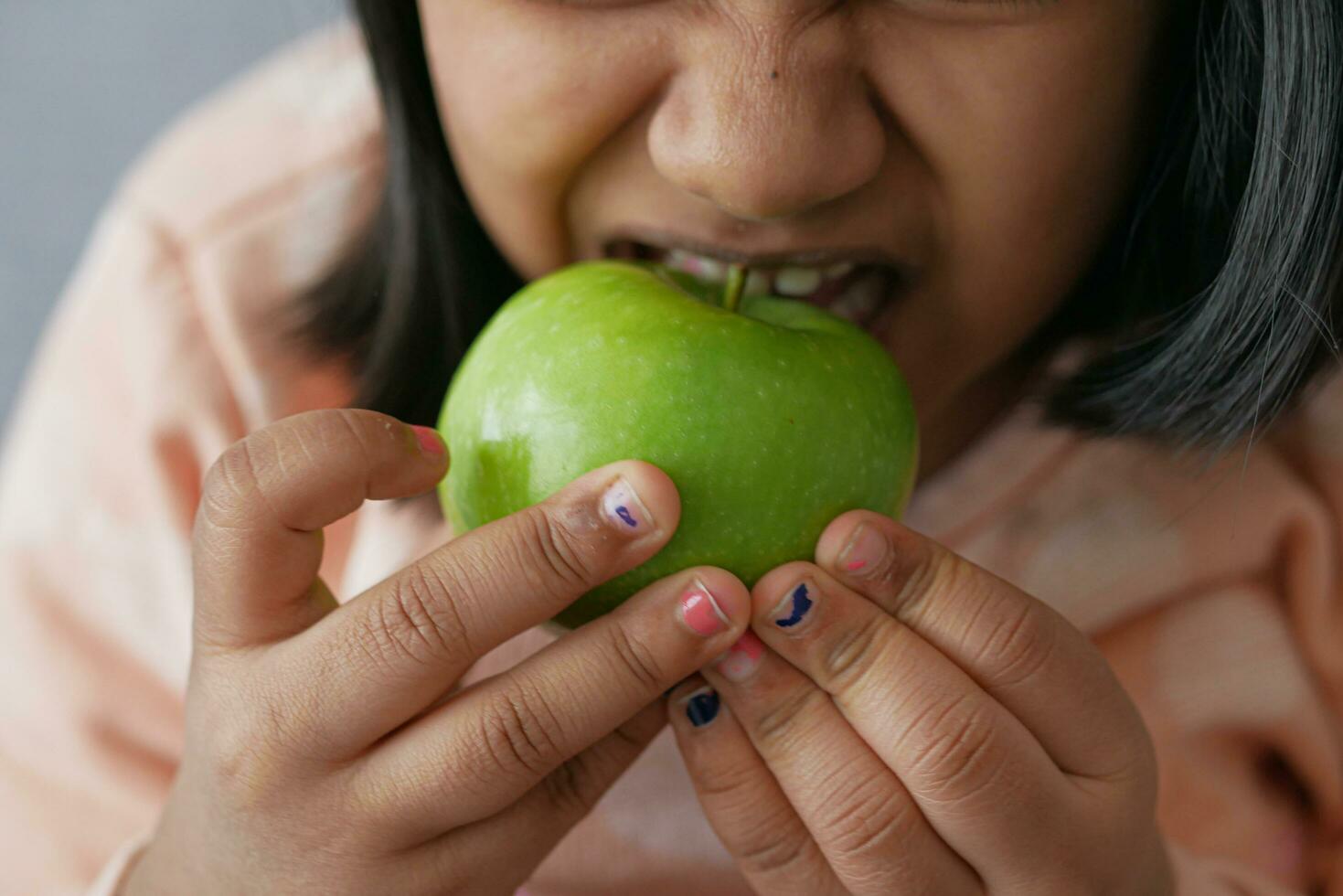 child mouth eating apple closeup photo