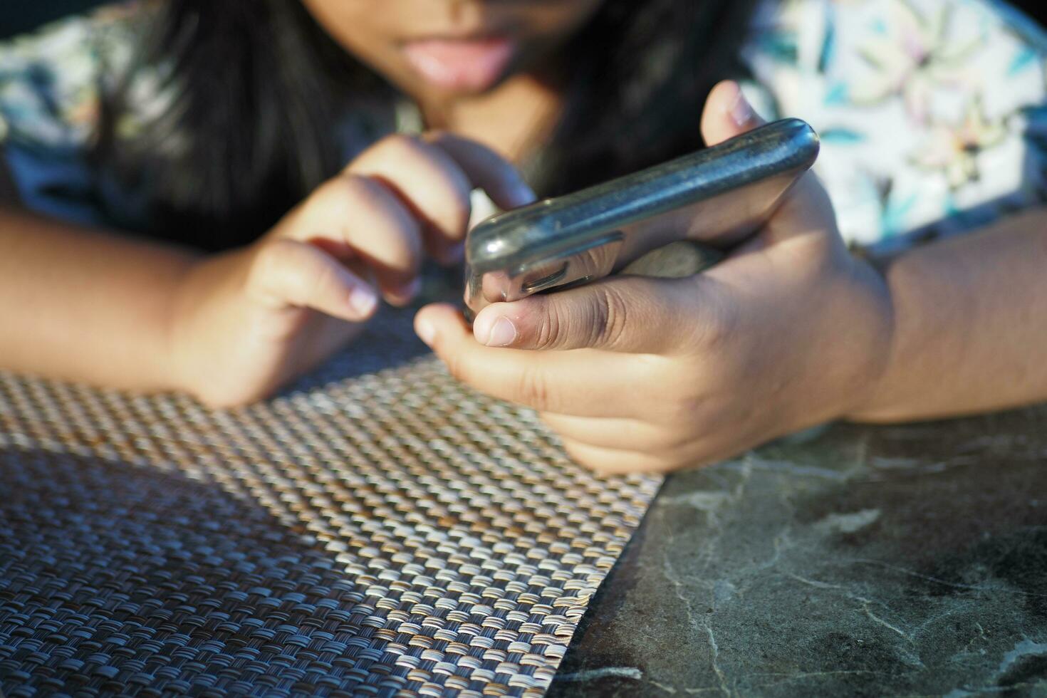 Child girl watching cartoon on smart phone photo