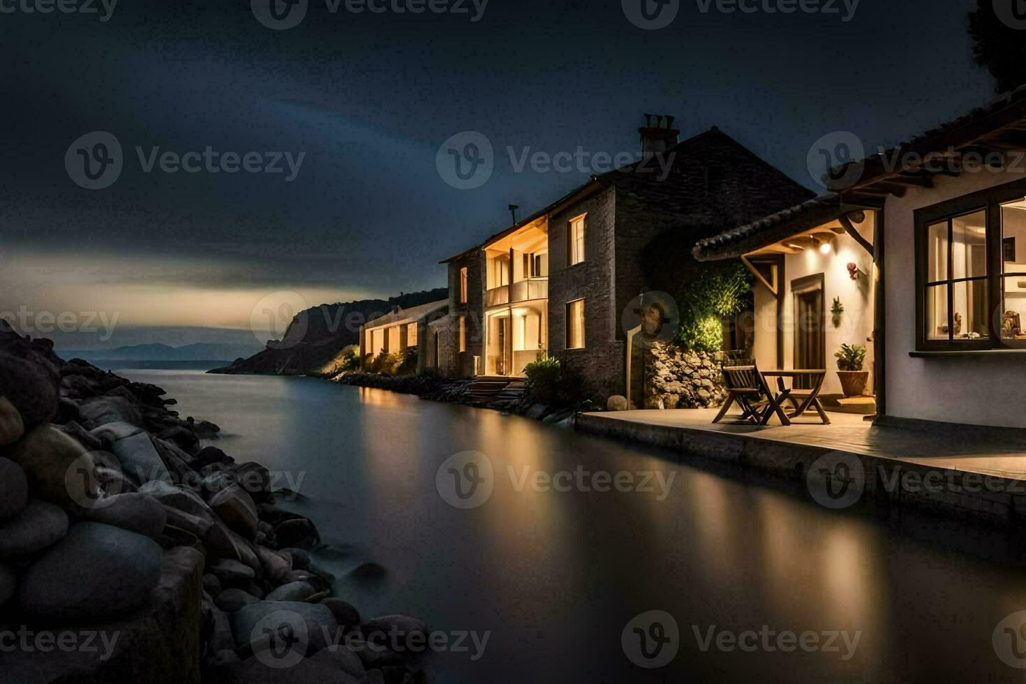 a house on the water at night with a view of the ocean. AI-Generated photo