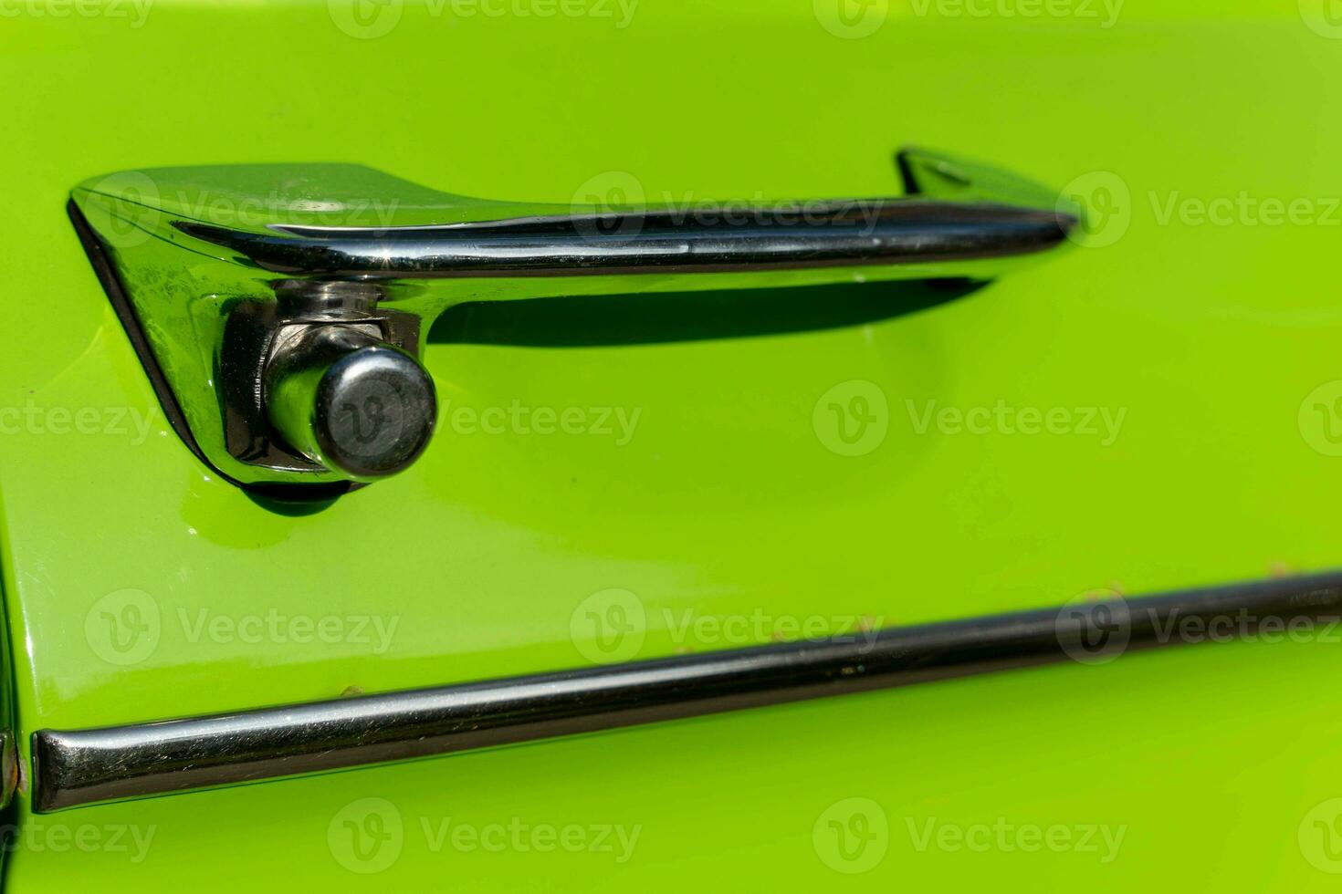 metal chrome door opening handle of an old classic car photo