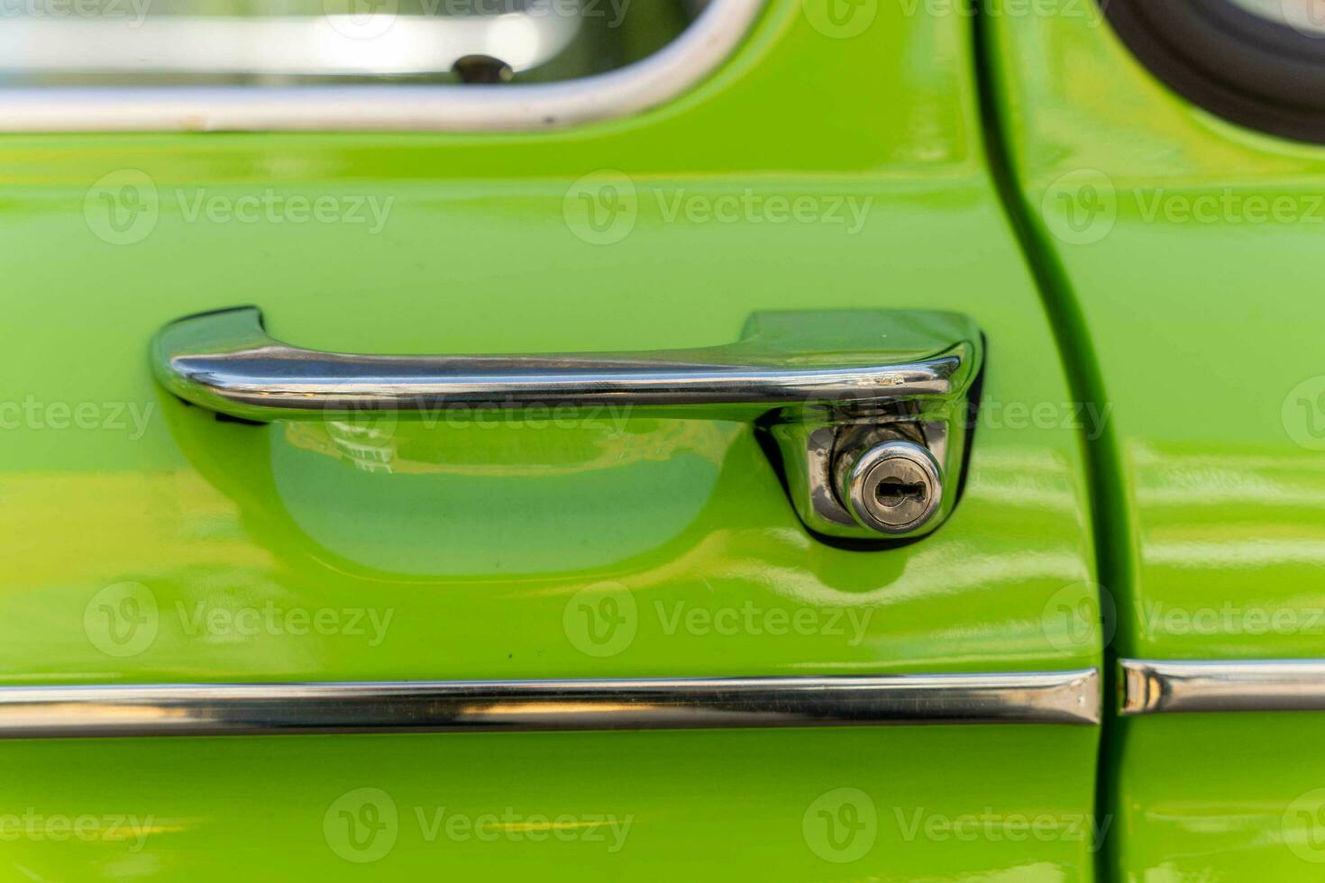 metal chrome door opening handle of an old classic car photo