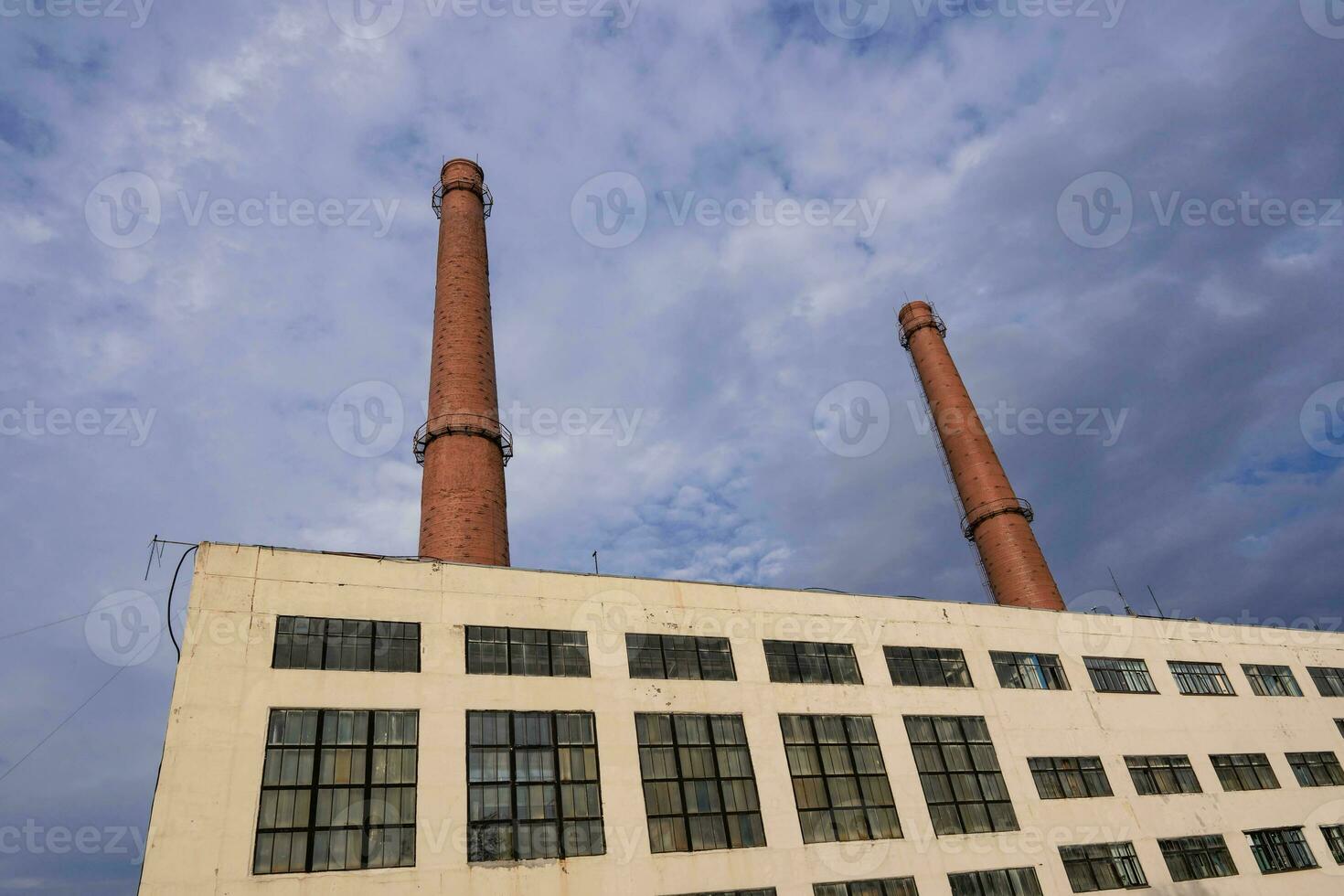 The pipes of the plant and the industrial old factory building photo