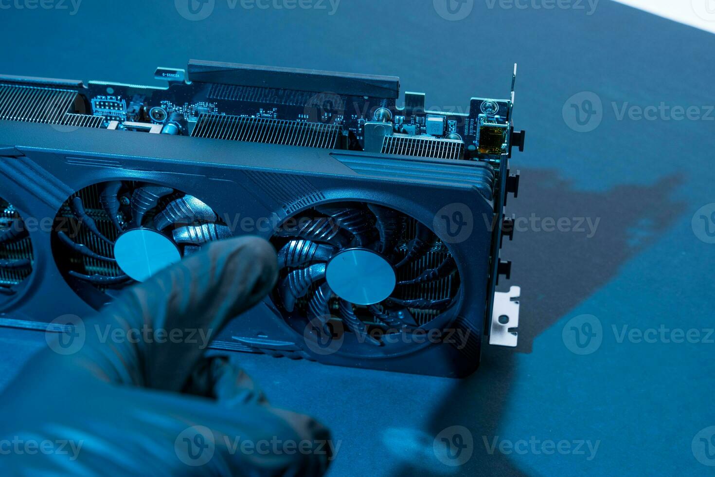 hand of a computer technician holds a modern powerful video game card photo