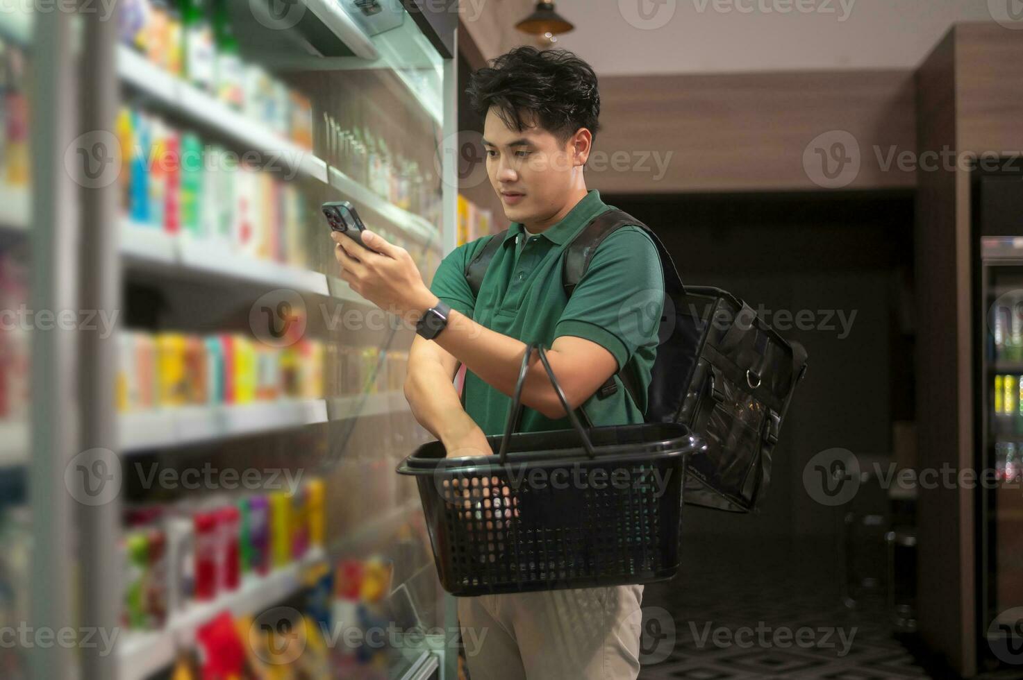 An Asian man delivery choosing goods from online order in supermarket , online delivery service concept photo