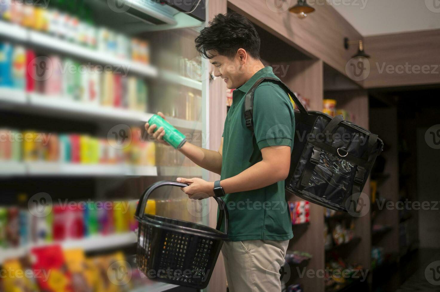 An Asian man delivery choosing goods from online order in supermarket , online delivery service concept photo