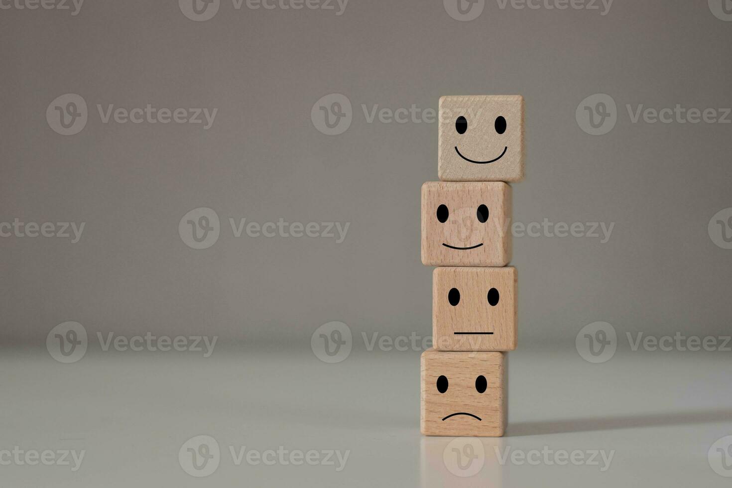 Customer services best excellent business rating experience. Face emotional symbol on wooden blocks cube. photo