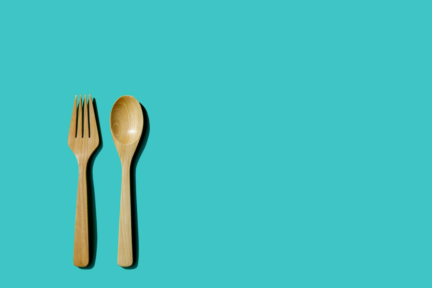 wooden spoon and fork, light and shadow Top view with space for your recipes. photo