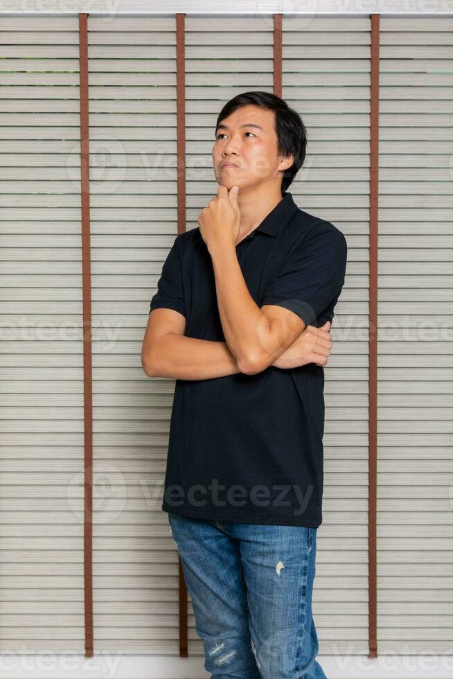 Portrait of a man Asian standing in black t-shirt and shorts. Isolated  on background with copy space and clipping path photo