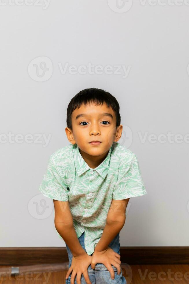 Cute little boy in casual outfit on background photo