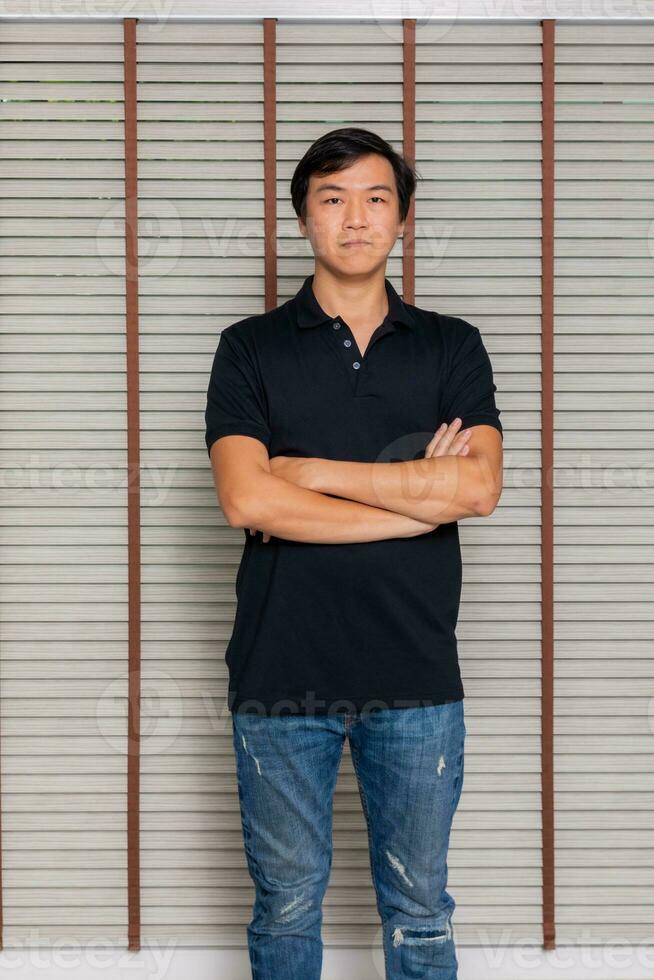 Portrait of a man Asian standing in black t-shirt and shorts. Isolated  on background with copy space and clipping path photo