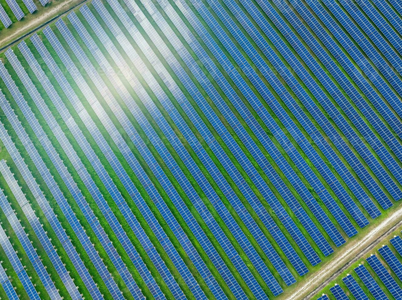 Aerial view of solar farm. Solar power for green energy. Sustainable resources. Solar cell panels use sun light as a source to generate electricity. Photovoltaics or PV. Sustainable renewable energy. photo