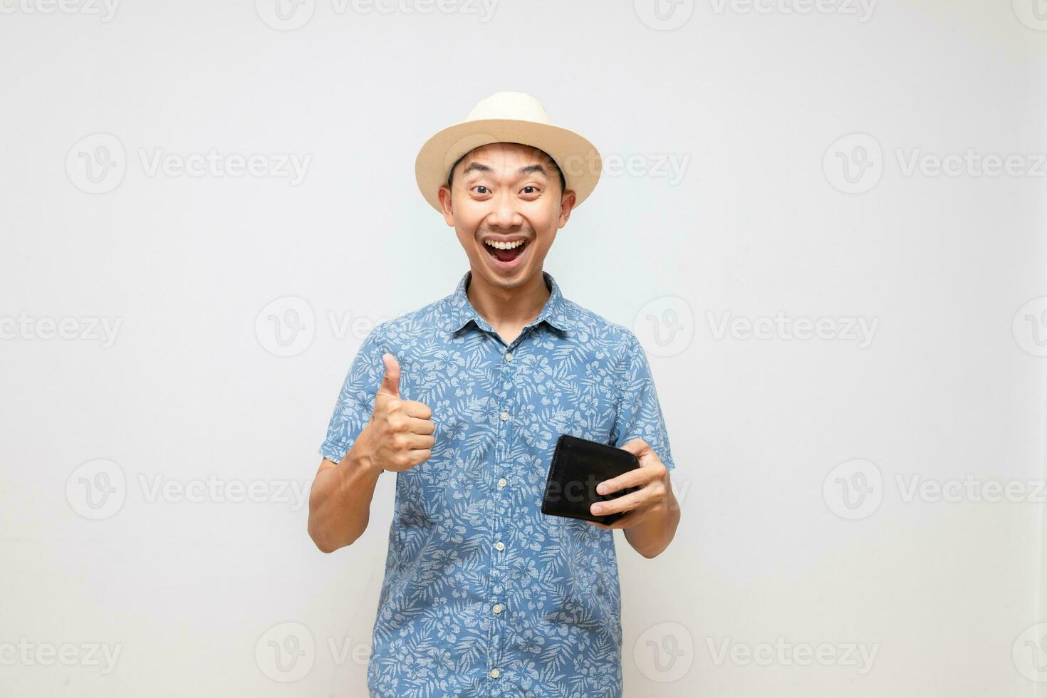 Positive asian man blue shirt wear hat holding wallet amazed show thumb up isolated photo