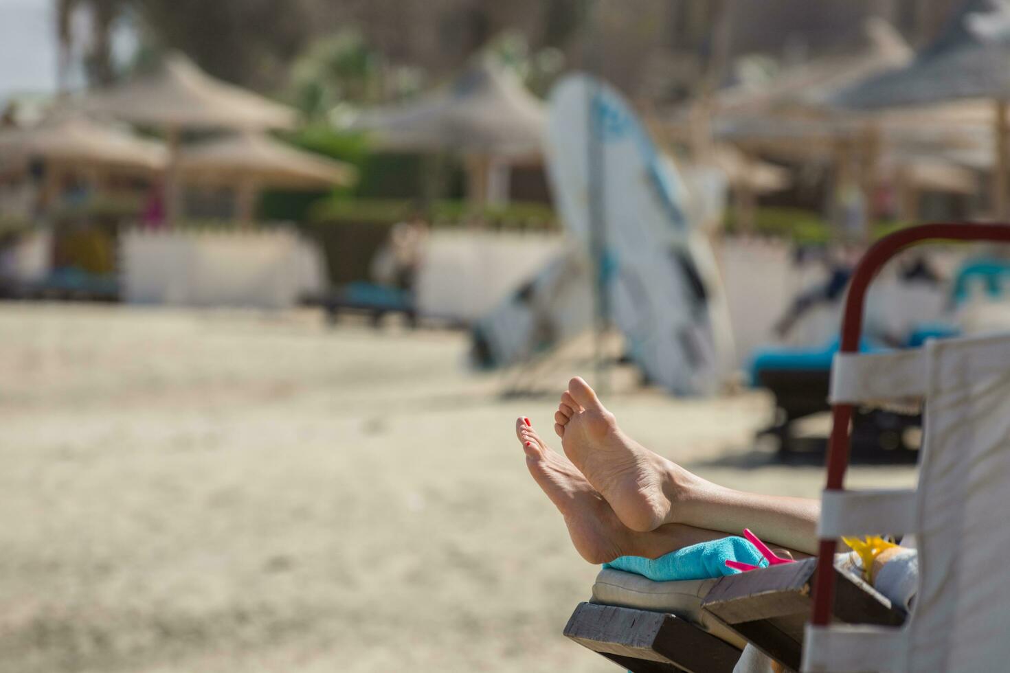 woman feet during lying in the sun on a sunbed at the beach on vacation photo