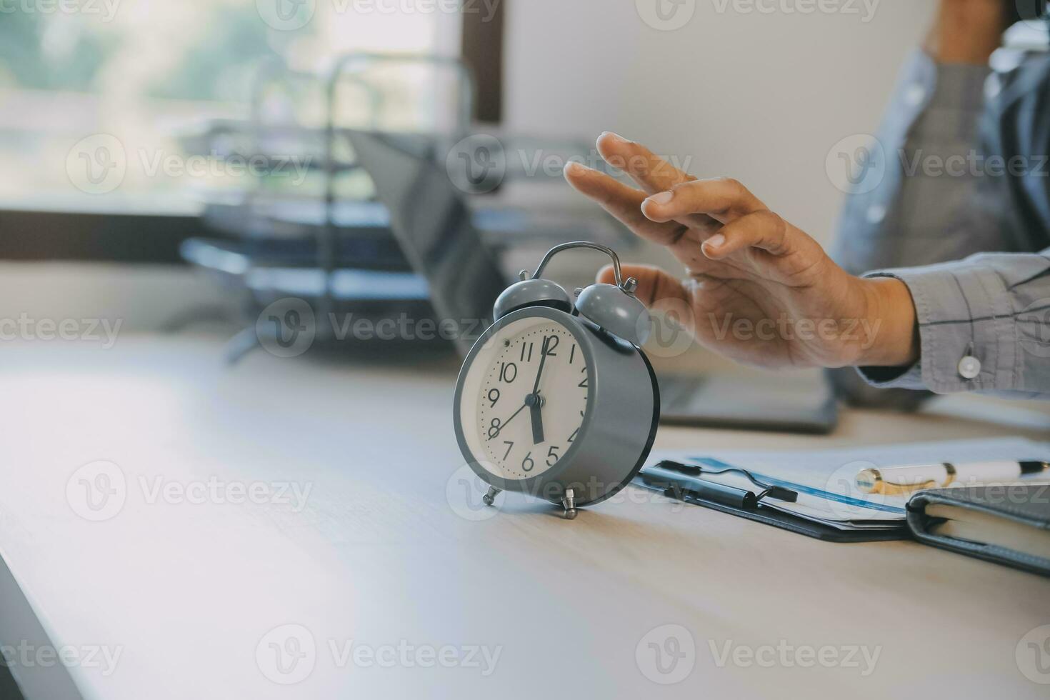 Business working times concept people work typing on laptop computer overlay with in time clock to lunch break photo