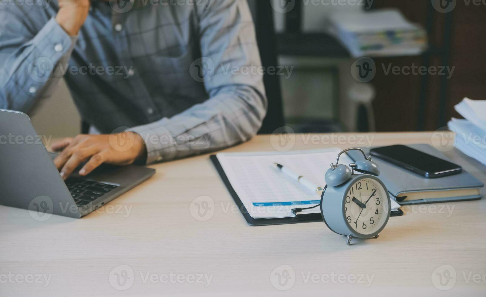 Business working times concept people work typing on laptop computer overlay with in time clock to lunch break photo
