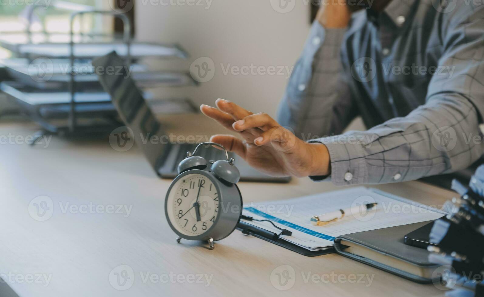 Business working times concept people work typing on laptop computer overlay with in time clock to lunch break photo