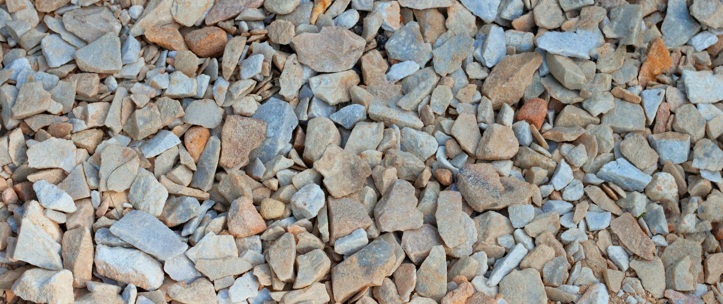 Crushed stone brown gray background texture, top view. Natural stone gravel. AI generated. photo