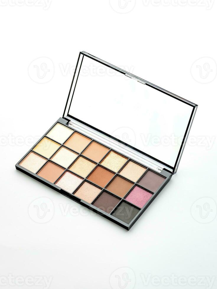 Close up of colorful eyeshadow palette isolated on white background. Open makeup case. Trendy pastel and bright colors for visage photo
