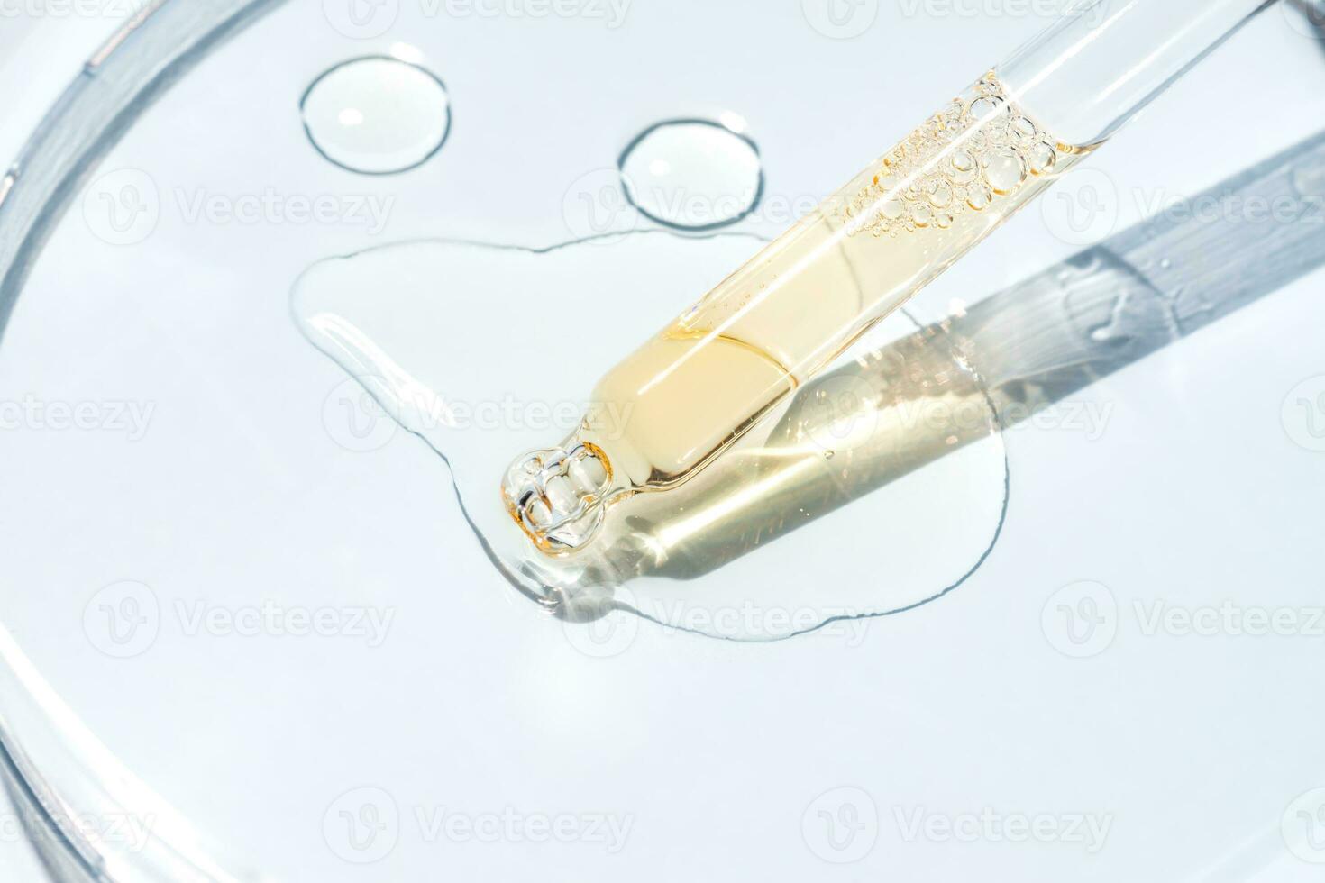 Cosmetic pipette with oil on blue background close-up. Stylish concept of organic essences, beauty and health products. Modern apothecary. Close up photo
