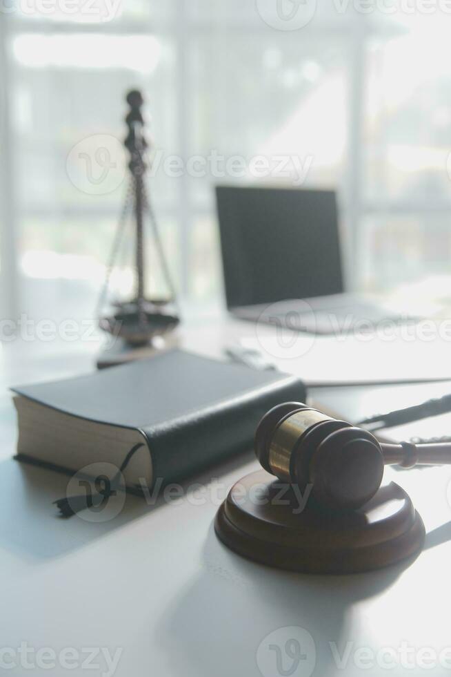 Business and lawyers discussing contract papers with brass scale on desk in office. Law, legal services, advice, justice and law concept picture with film grain effect photo