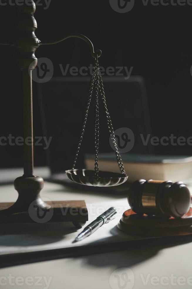 Business and lawyers discussing contract papers with brass scale on desk in office. Law, legal services, advice, justice and law concept picture with film grain effect photo