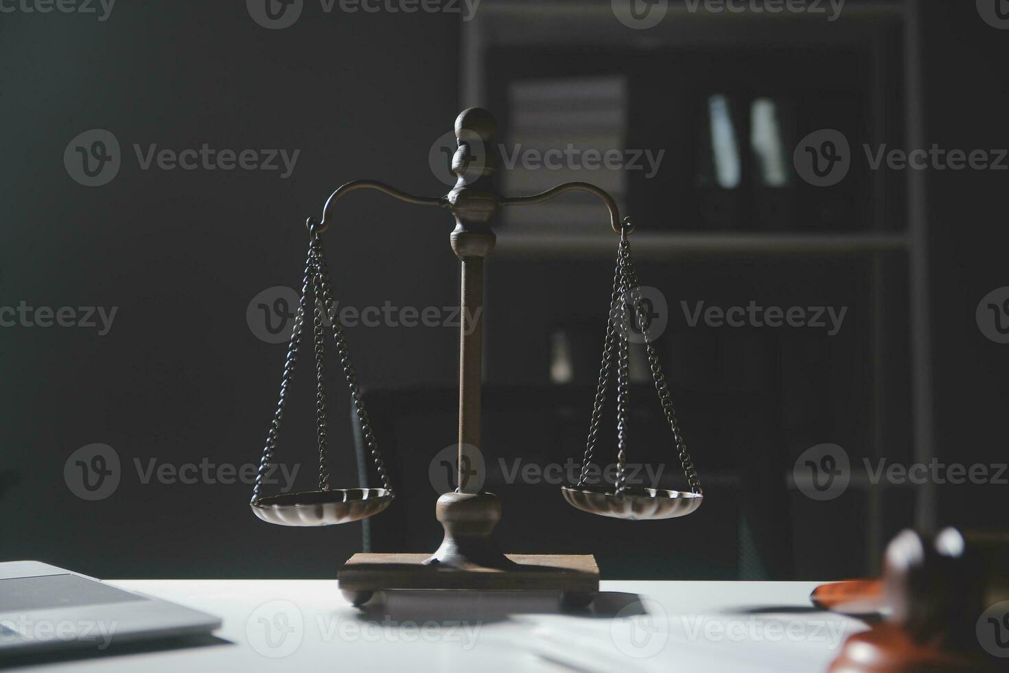 Business and lawyers discussing contract papers with brass scale on desk in office. Law, legal services, advice, justice and law concept picture with film grain effect photo