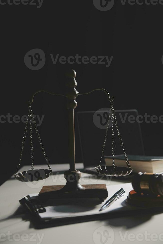 Business and lawyers discussing contract papers with brass scale on desk in office. Law, legal services, advice, justice and law concept picture with film grain effect photo