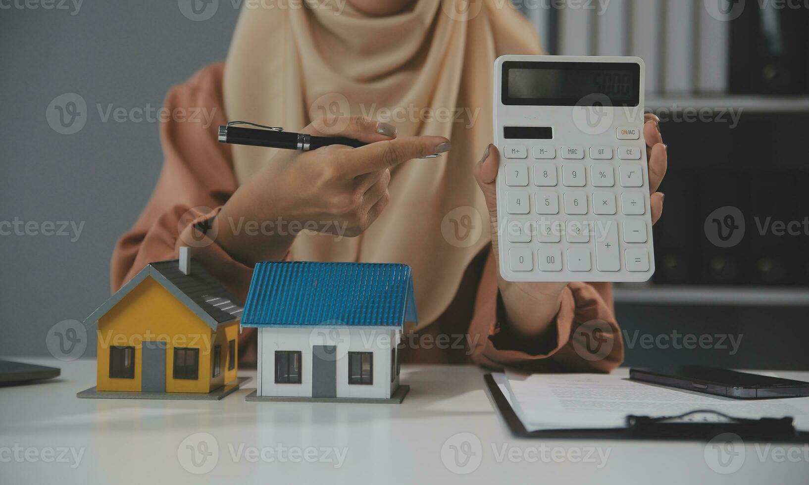 Real estate agent and customer signing contract to buy house, insurance or loan real estate.rent a house,get insurance or loan real estate or property. photo