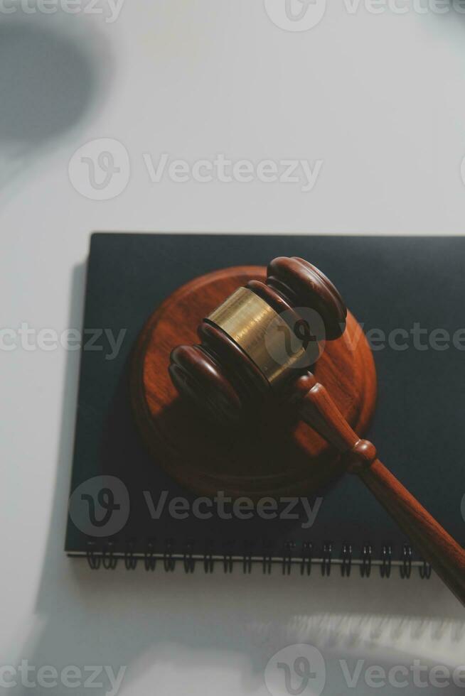 Business and lawyers discussing contract papers with brass scale on desk in office. Law, legal services, advice, justice and law concept picture with film grain effect photo