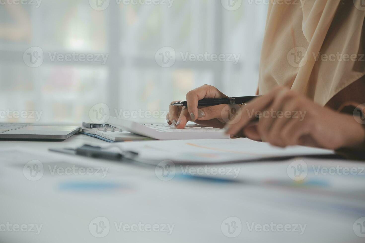 Businesswoman or accountant working Financial investment on calculator, calculate, analyze business and marketing growth on financial document data graph, Accounting, Economic, commercial concept. photo