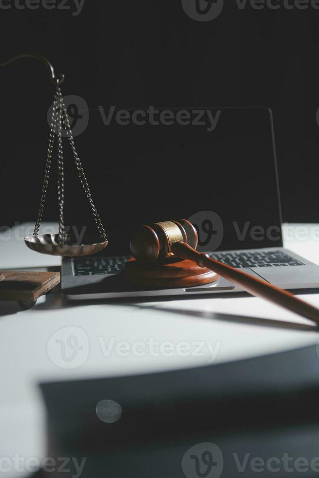 Business and lawyers discussing contract papers with brass scale on desk in office. Law, legal services, advice, justice and law concept picture with film grain effect photo
