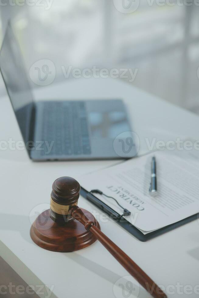 Business and lawyers discussing contract papers with brass scale on desk in office. Law, legal services, advice, justice and law concept picture with film grain effect photo
