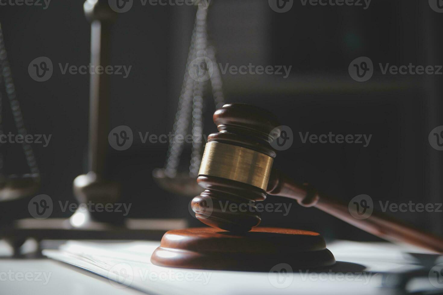 Business and lawyers discussing contract papers with brass scale on desk in office. Law, legal services, advice, justice and law concept picture with film grain effect photo