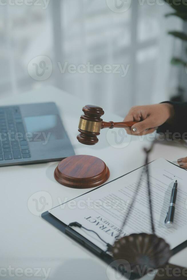 Business and lawyers discussing contract papers with brass scale on desk in office. Law, legal services, advice, justice and law concept picture with film grain effect photo