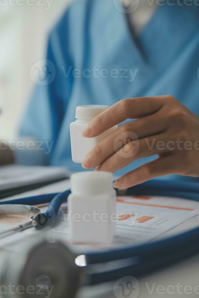 Stethoscope and background doctor using laptop at desk in clinic working on computer at room office. photo