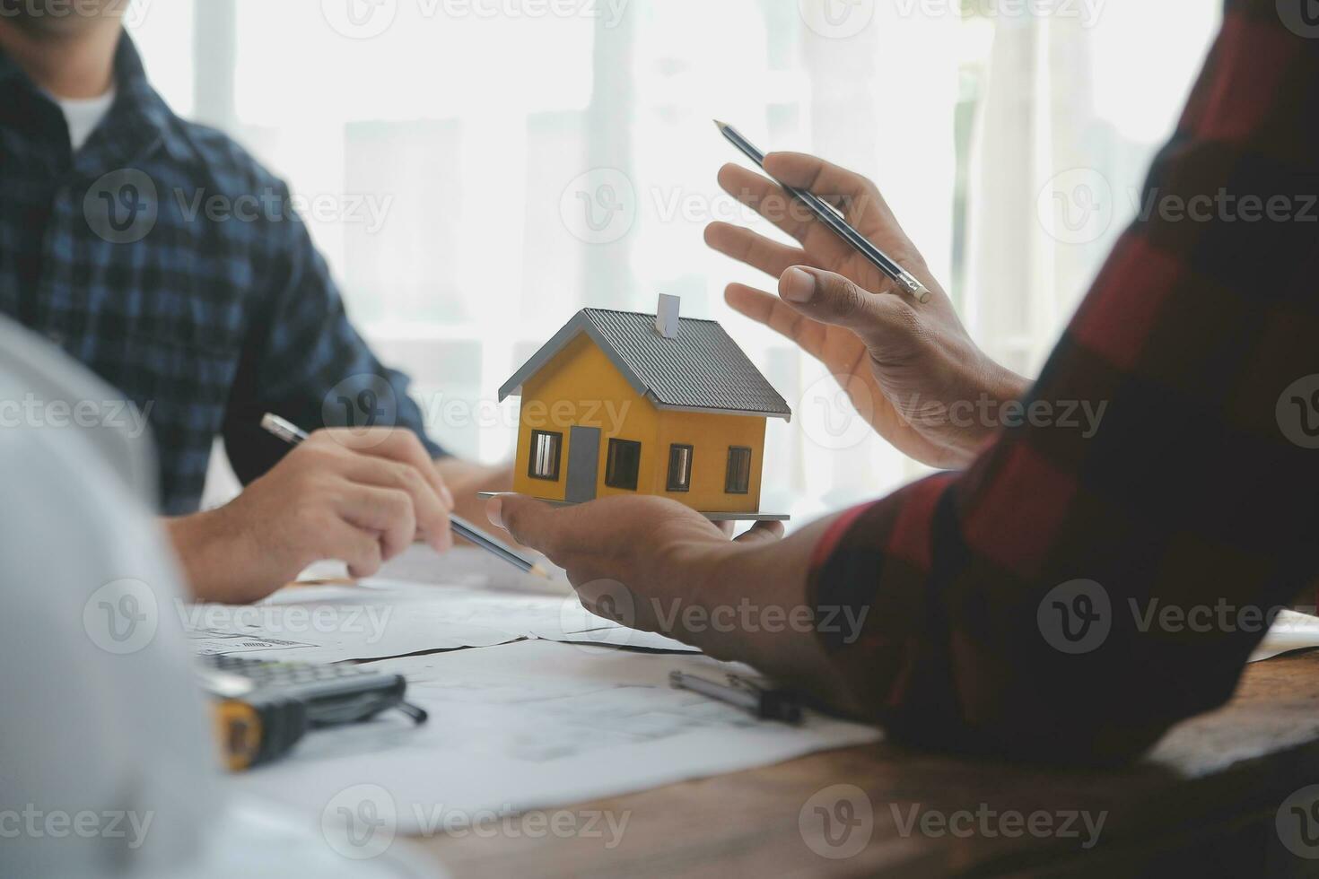 Close up of civil male engineer asian working on blueprint architectural project at construction site at desk in office. photo