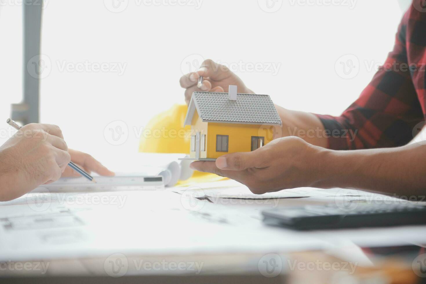 Close up of civil male engineer asian working on blueprint architectural project at construction site at desk in office. photo