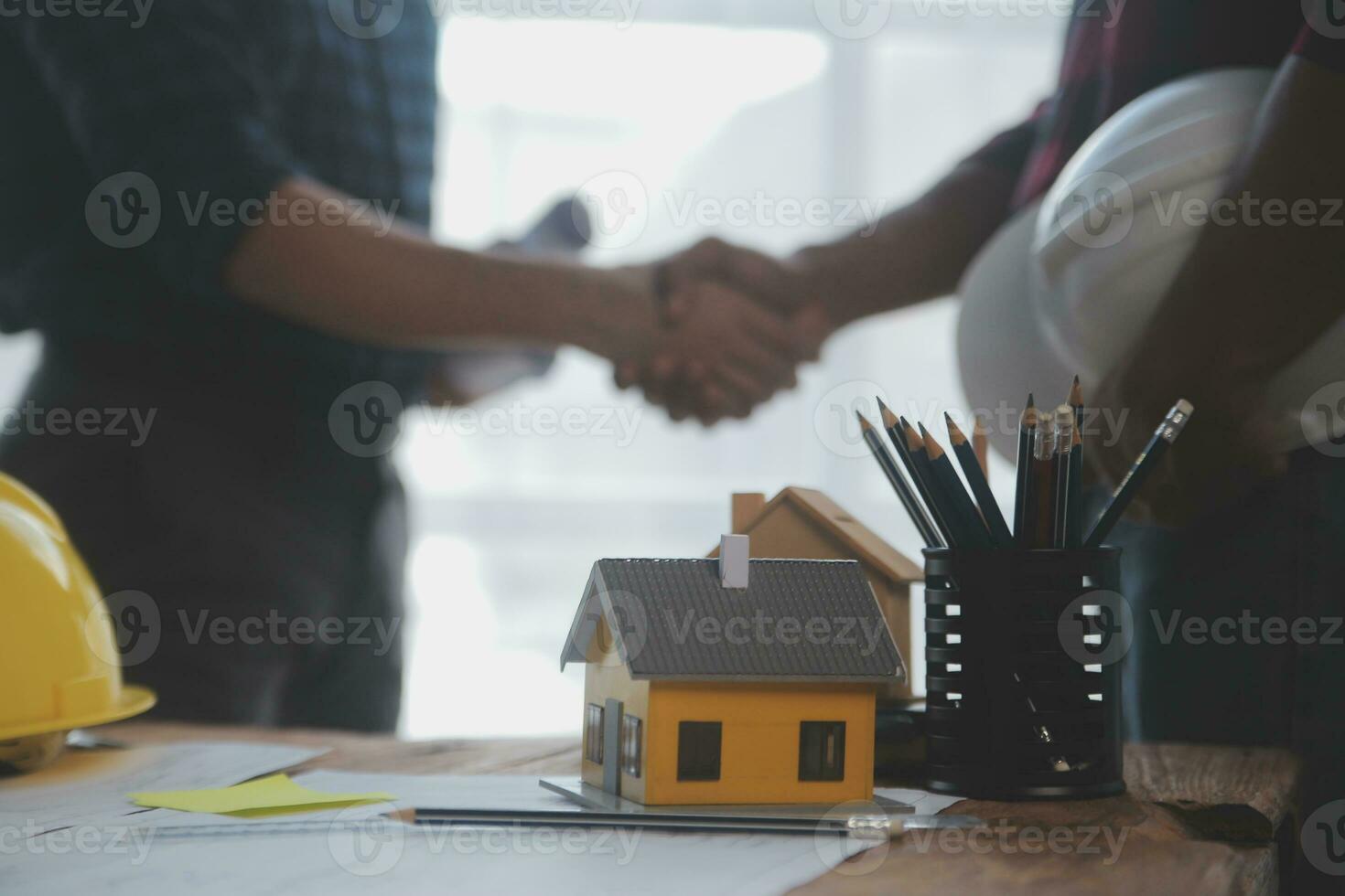 Close up of civil male engineer asian working on blueprint architectural project at construction site at desk in office. photo