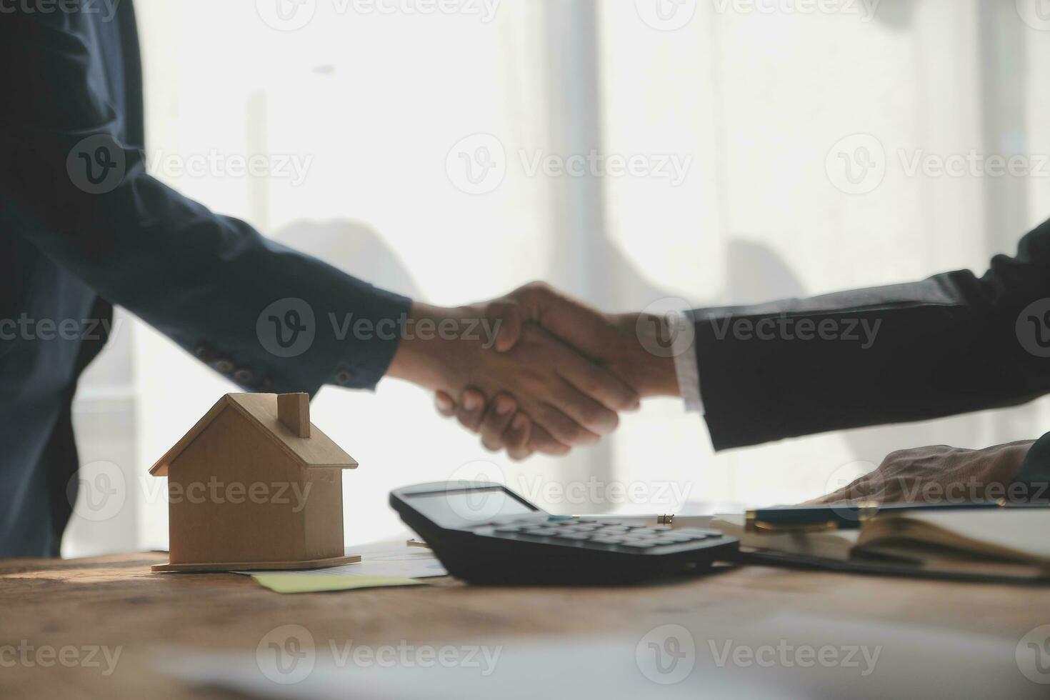 Real estate brokerage agent Deliver a sample of a model house to the customer, mortgage loan agreement Making lease and buy and sell house And contract home insurance mortgage loan concept photo