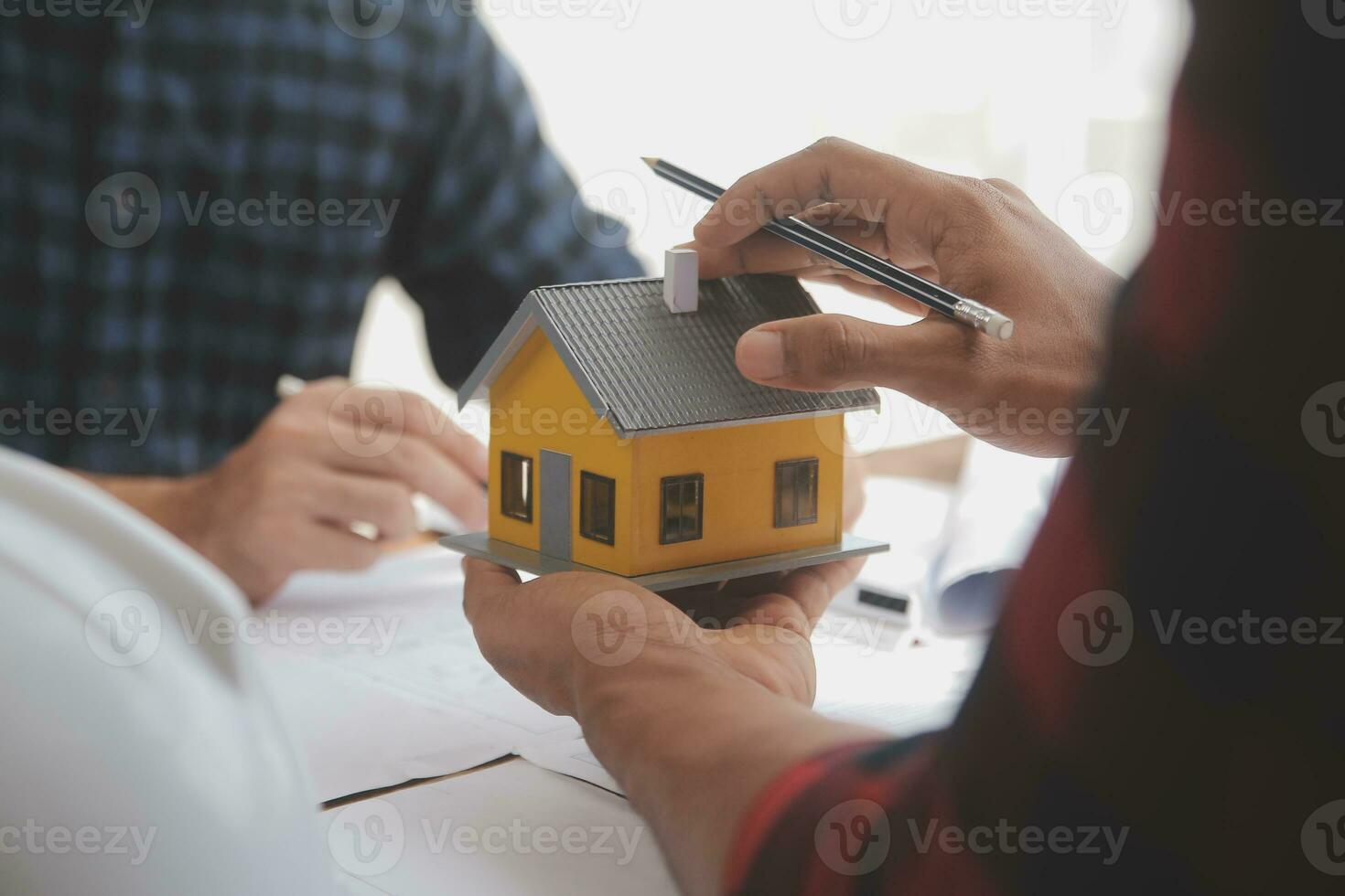 Close up of civil male engineer asian working on blueprint architectural project at construction site at desk in office. photo
